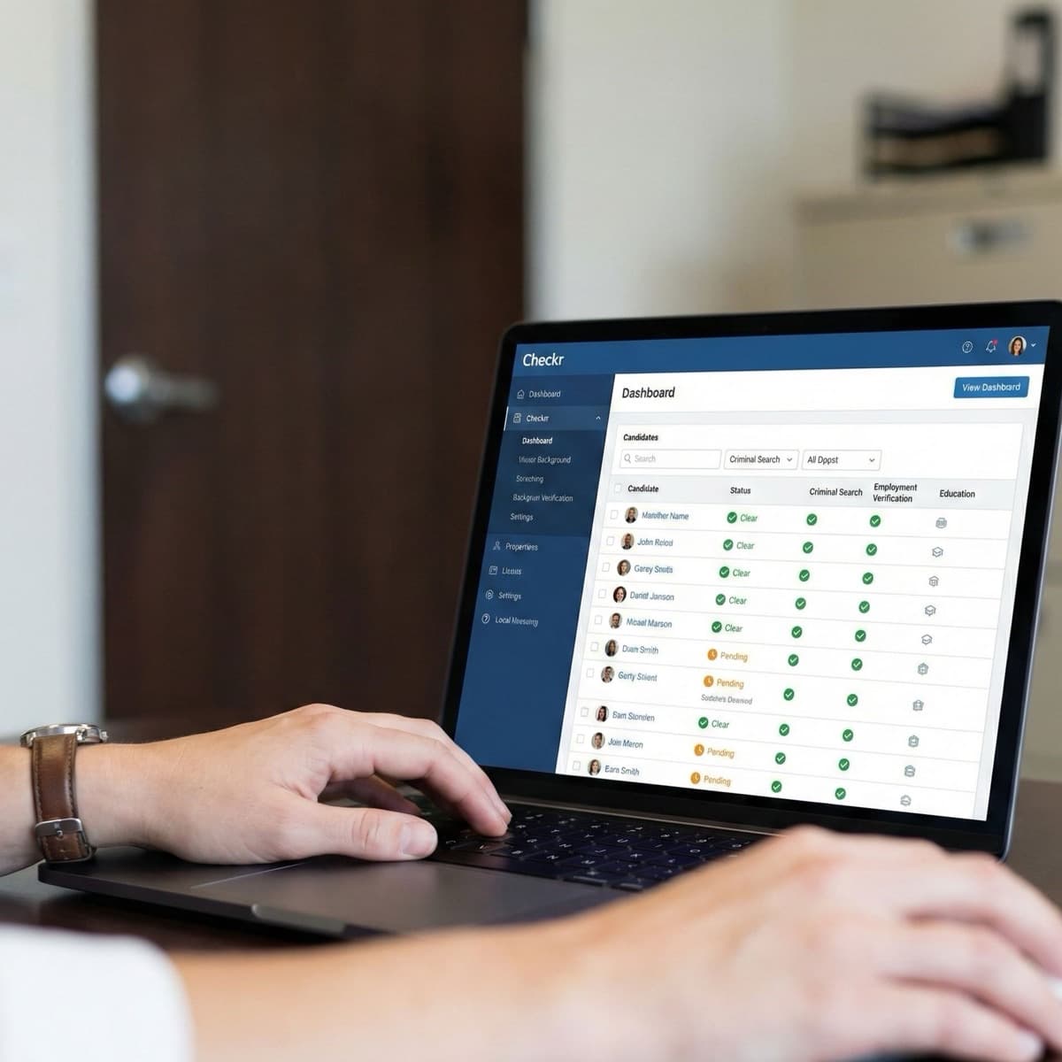 A laptop screen showing a work for Background Checks in a home office